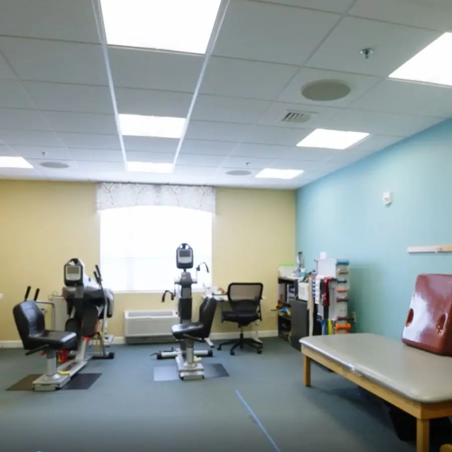Physical therapy treatment room featuring exercise equipment, therapy tables, and a bright, inviting atmosphere. Ideal for rehabilitation and patient care.